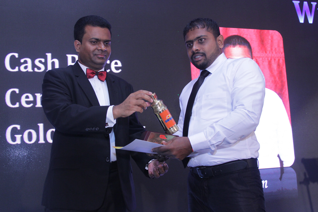 Executive Director of C. W. Mackie PLC - Mr. Mangala Perera handing over the Best Sales Representative Trophy to Sales Representative - Mr. Asen Thilakarathna, at the Scan Annual Sales Conference 2017/18 - Star Awards Night, held at Club Palm Bay Marawilla.