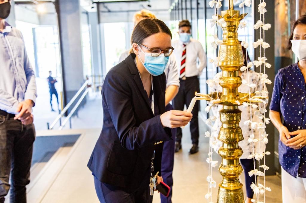 Ms Hilde Berg-Hansen, Chargé d’affaires, a.i. lighting the traditional oil lamp at the new premises. (credit Milan Joiey Smahon)